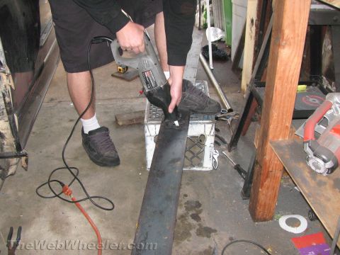 1987 Suzuki Samurai - Metal fabrication in progress: a person cuts a steel bar with a reciprocating saw.