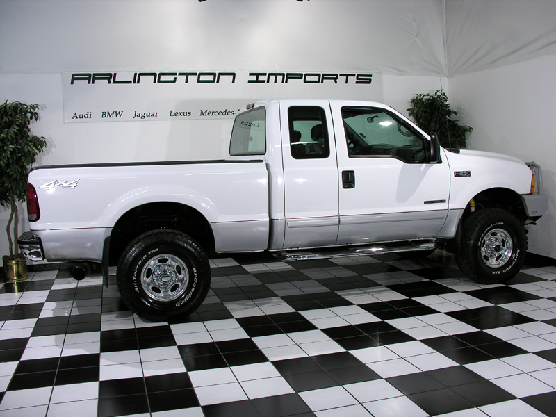 White 2001 Ford F-250 pickup truck, side view