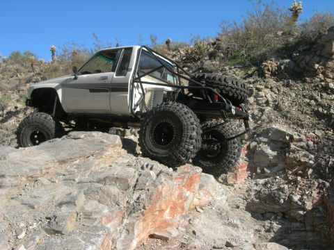 1986 Toyota Hilux - Modified 1986 Toyota Hilux tackling rocky terrain off-road.