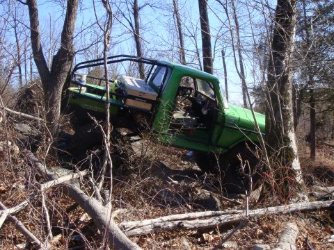 1978 Ford Bronco - This modified truck navigates a challenging off-road course with steep inclines and obstacles.