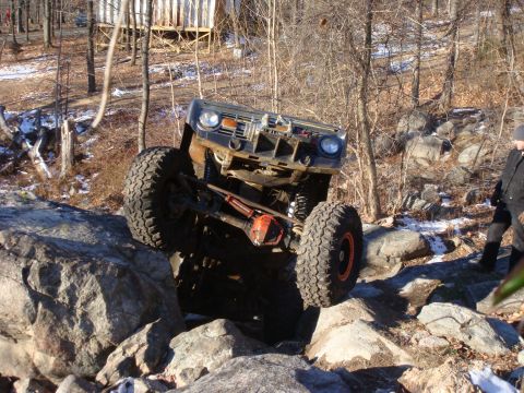 1978 Ford Bronco - A black 1978 Ford Bronco navigates a rocky trail, demonstrating its off-road capabilities.