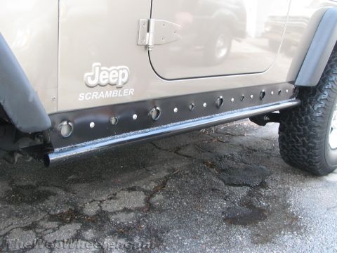 1987 Suzuki Samurai - Custom rock sliders installed on a Jeep Scrambler, showing off their protective design.