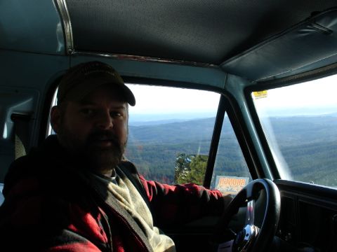 1978 Ford Bronco - Driver's view from inside a 1978 Ford Bronco, overlooking a vast expanse of trees and hills.