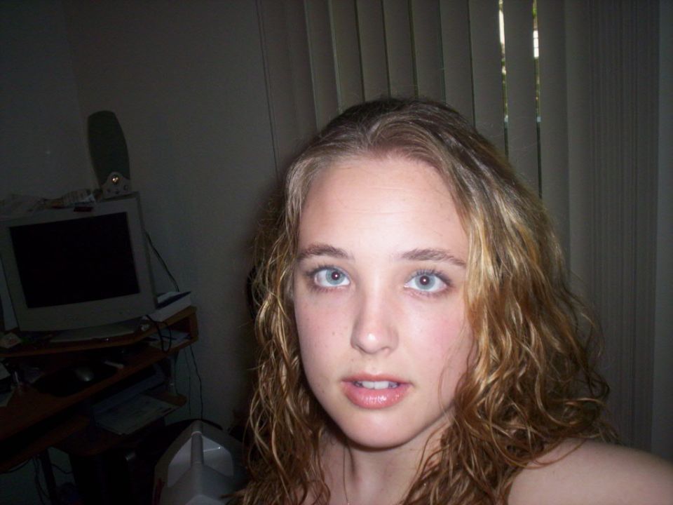 Woman with blue eyes and curly blonde hair