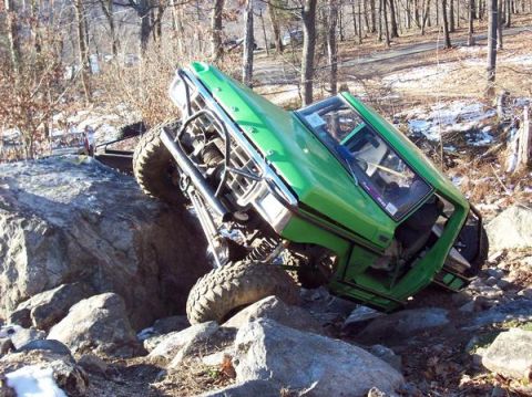 1978 Ford Bronco - This heavily modified off-road vehicle navigates a rocky terrain, its suspension and winch capabilities.
