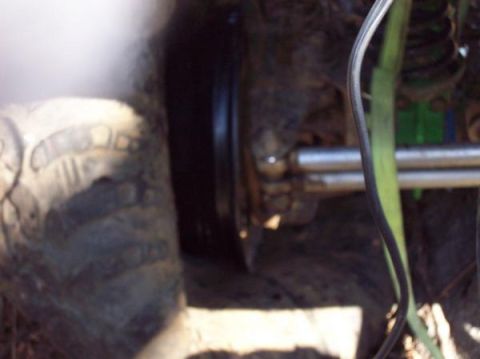 1978 Ford Bronco - This image shows a close-up view of a vehicle's tire and suspension system, with some mechanical parts visible.