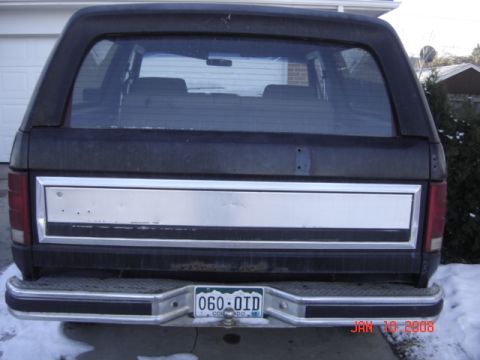 1985 Ford Bronco - The rear of a Ford Bronco is shown, a chrome accent panel and a Colorado license plate.