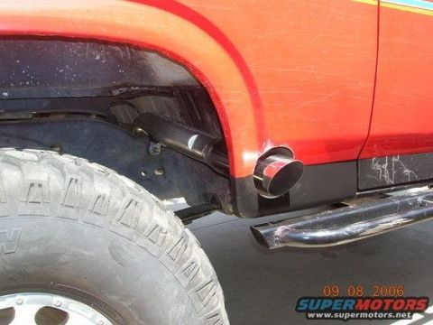 1986 Ford Bronco - A vehicle's exhaust pipe exits through the body panel near the rear tire. The date 09 08 2006 is visible.