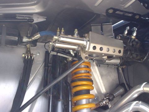 1986 Ford Bronco - Undercarriage view showing suspension components and hydraulic lines, with a watermark for Supermotors.net.