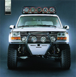 1986 Ford Bronco - This 1986 Ford Bronco features a custom front bumper and a roof-mounted light bar, ready for off-road adventures.