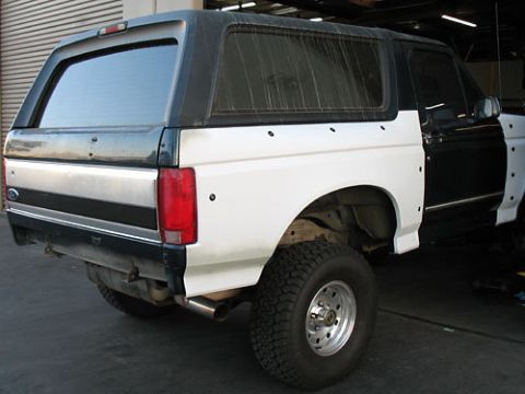 1986 Ford Bronco - This Ford Bronco appears to be undergoing bodywork, with unpainted fenders and a two-tone paint scheme.