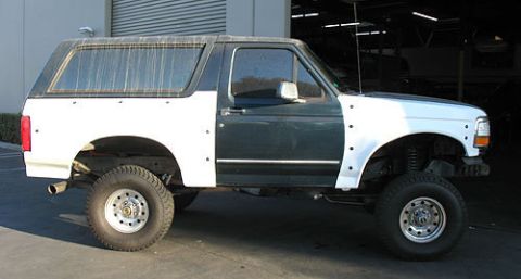 1986 Ford Bronco - This Ford Bronco appears to be undergoing repairs or modifications, with different colored body panels visible.