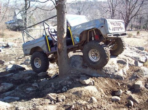 1978 Ford Bronco - This modified 1978 Ford Bronco is shown off-roading over a challenging rock obstacle.