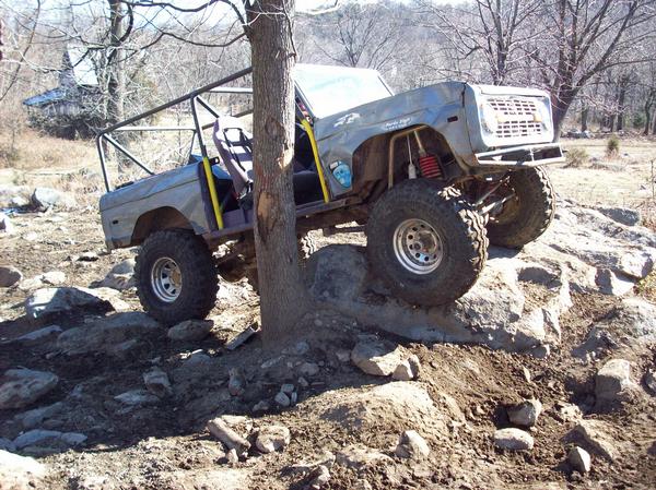1978 Ford Bronco with roll cage navigating rocky terrain