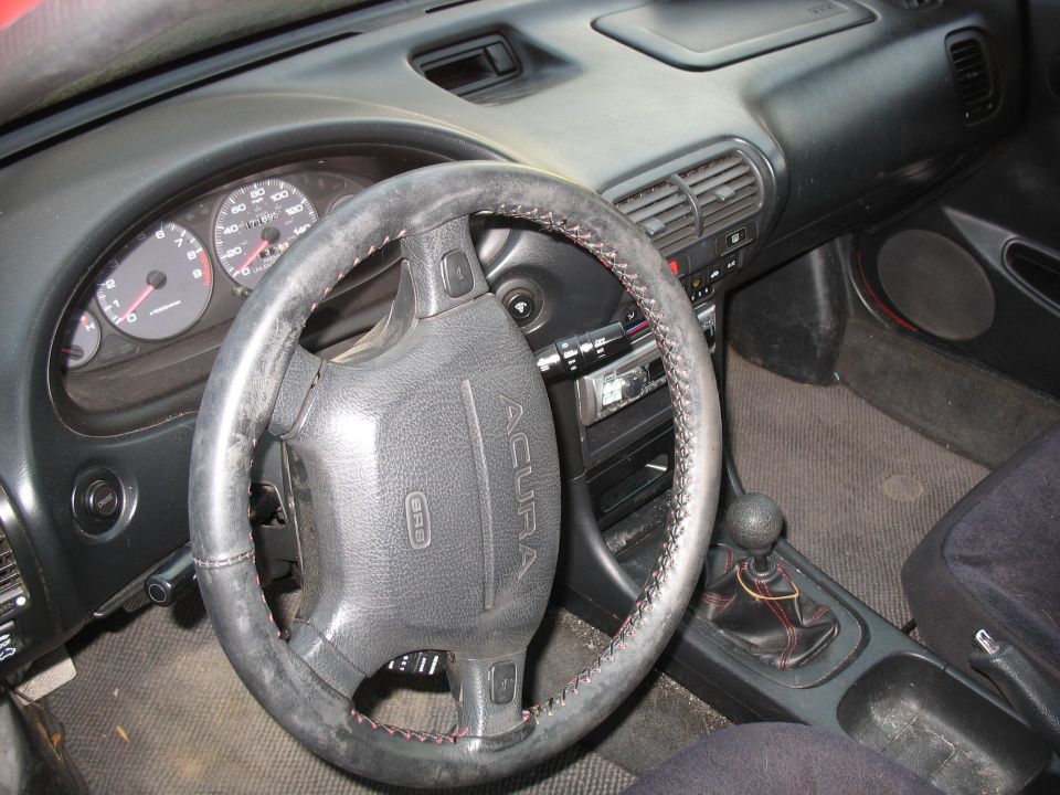 Acura Integra interior with wrapped steering wheel, gauges and manual shifter