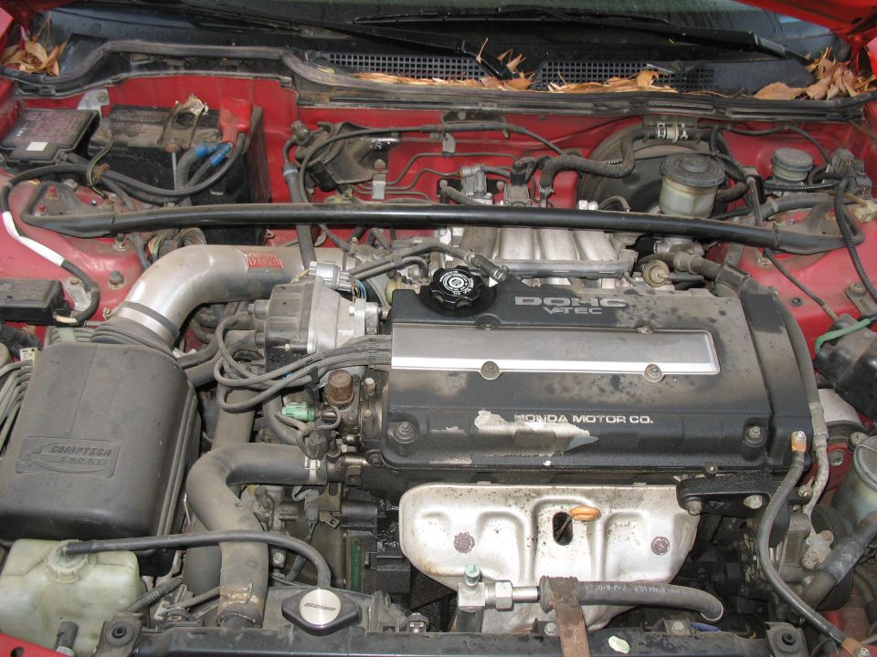 Red car engine bay with DOHC VTEC engine and Comptech intake