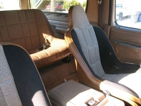 1986 Ford Bronco - The interior of this 1986 Ford Bronco features patterned fabric seats and a center console.