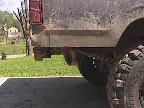 1980 Dodge Magnum - Rear view of a weathered pickup truck, focusing on the taillight and suspension components.