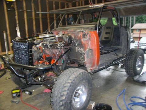 1979 Ford Bronco - This custom off-road buggy is in a state of construction, an exposed engine, roll cage, and large tires.