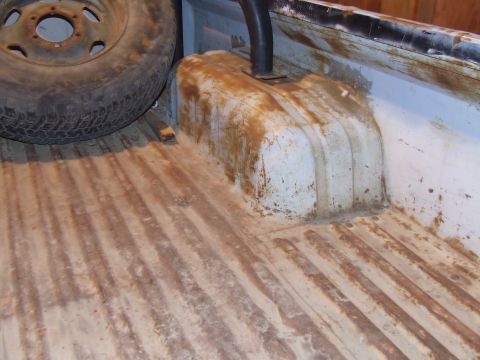 1990 Ford Bronco - Spare tire and fuel tank are visible in the bed of a truck.
