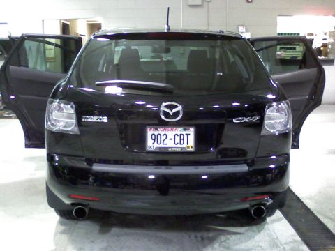 2007 Mazda CX-7 - Rear view of a black 2007 Mazda CX-7 SUV with its doors open.