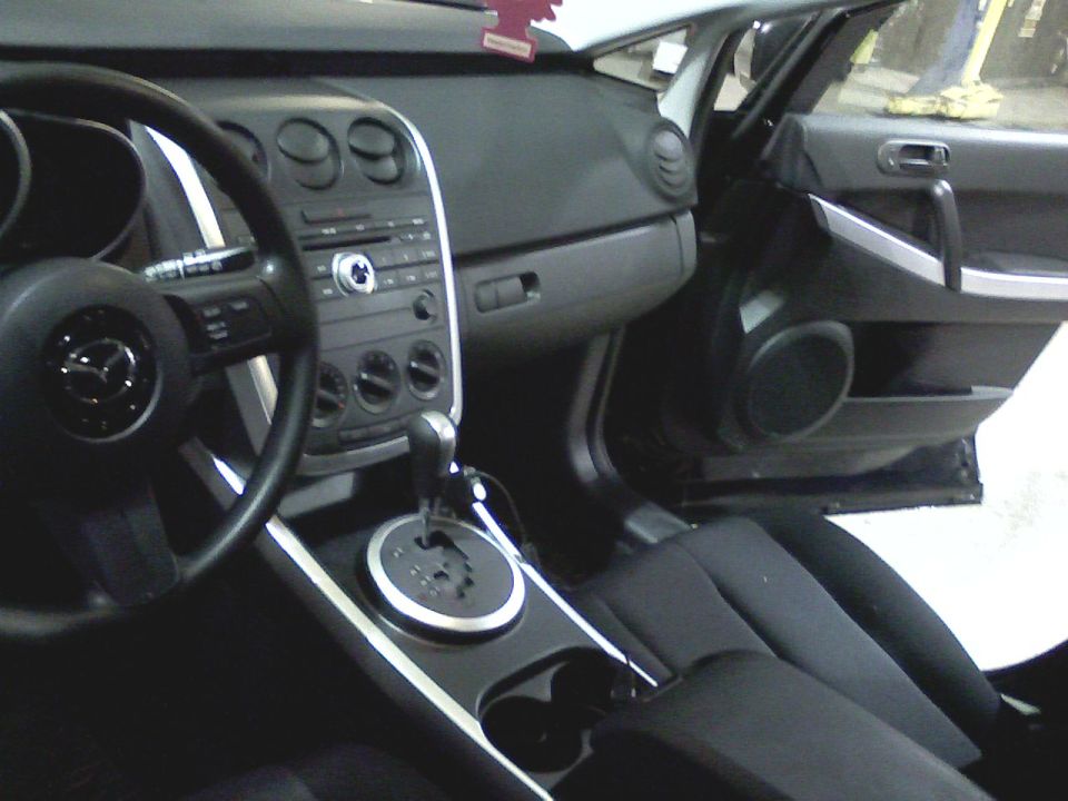 2007 Mazda CX-7 interior showing dashboard, steering wheel, gear shifter, and door panel