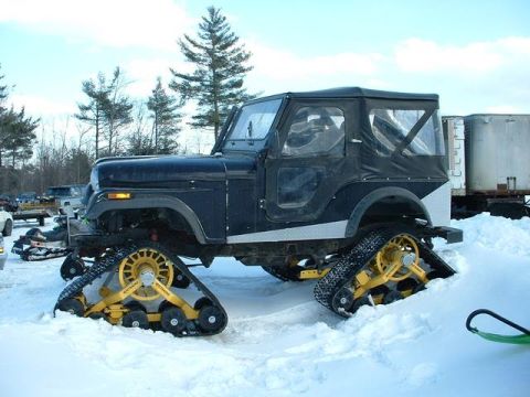 1987 Suzuki Samurai - Jeep CJ fitted with snow tracks for off-road winter travel.