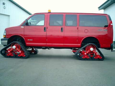 1987 Suzuki Samurai - This red van has been modified with red snow tracks for off-road capability.