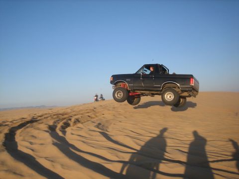 1995 Ford Bronco - This 1995 Ford Bronco is captured mid-air while cresting a sand dune.