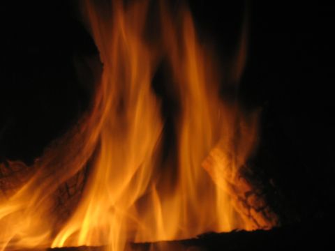 1995 Ford Bronco - Flames from a fire burn brightly in the dark.