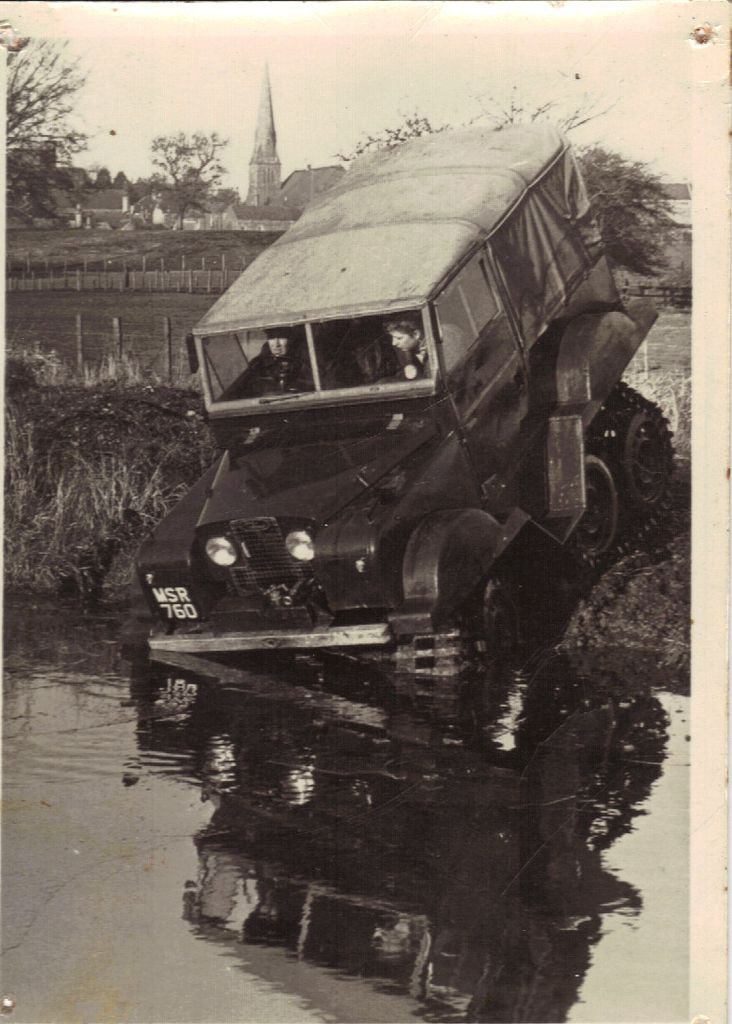 Vintage 4x4 with canvas top and plate MSR 760 climbing out of water