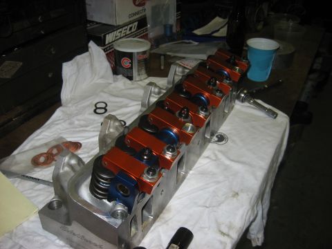 1965 Ford Galaxie - A disassembled engine cylinder head sits on a white cloth, ready for assembly or repair.