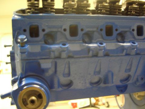 1996 Ford Bronco - Close-up of a blue engine block, showing valve springs and intake ports.