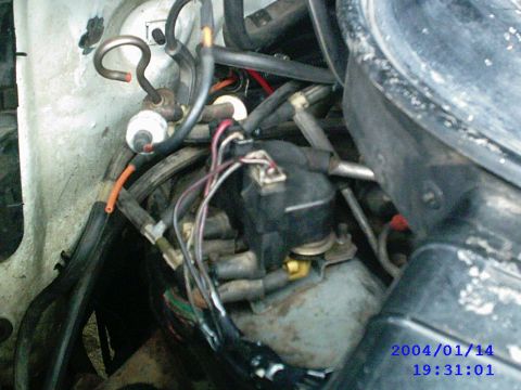 1984 Ford Bronco - Close-up view of an engine's distributor cap, wires, and associated hoses.
