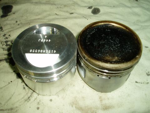 2000 Ford E350 - Comparison of a clean piston next to a heavily fouled piston, indicating engine wear or combustion issues.