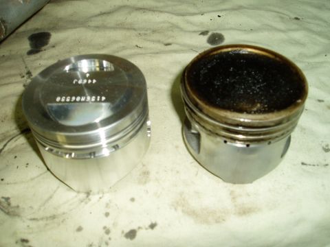 2000 Ford E350 - Comparison of a clean piston and one heavily coated in carbon deposits.
