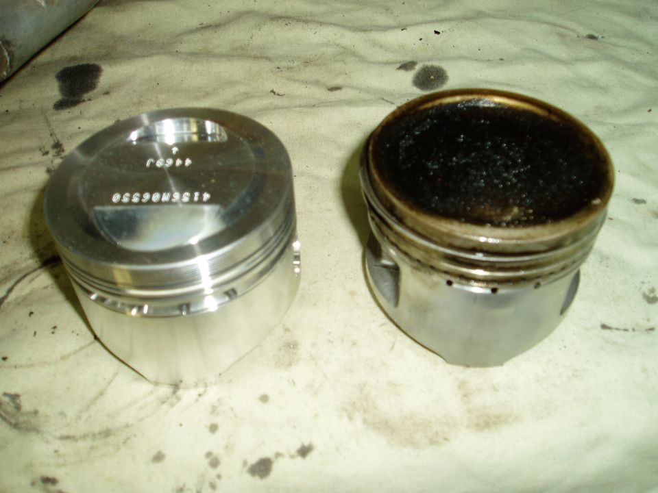 Clean piston next to carbon-covered piston