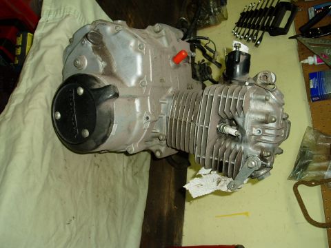 2000 Ford E350 - Engine part with 'HONDA' logo visible on a workbench.