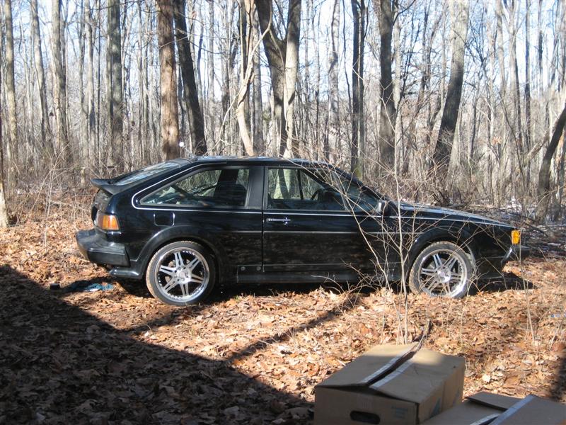 Black 1987 Volkswagen Scirocco side view in woods