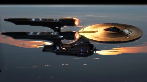 1986 Ford Bronco - The USS Enterprise NCC-1701 flies through the atmosphere above a city at dusk.