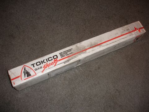 1993 Ford Taurus - A box of Tokico Gas Shocks is shown on a carpeted surface.