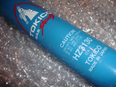 1993 Ford Taurus - A blue Tokico Gas Shocks part, model HZ3130, is shown with caution text and "Made in Japan" label.