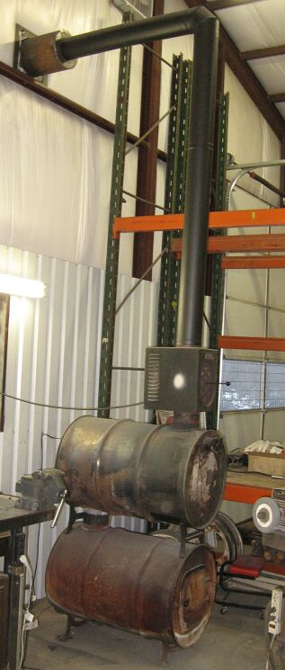 1986 Ford Ranger - This is a homemade wood stove made from two stacked barrels, with a metal pipe chimney.