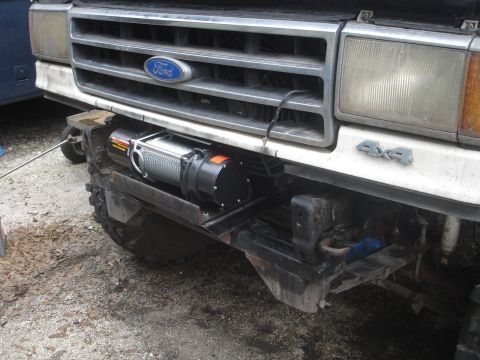 1989 Ford Bronco - Front view of a Ford truck with a winch installed. The grille and 4x4 badge are visible.