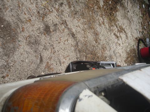 1989 Ford Bronco - A winch is mounted on the front of a vehicle, with a portion of the headlight visible.
