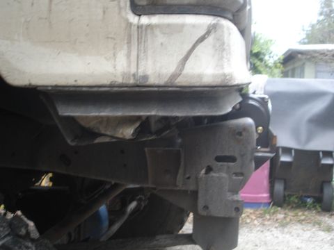 1989 Ford Bronco - Close-up of a vehicle's undercarriage, focusing on a winch mount and frame structure.