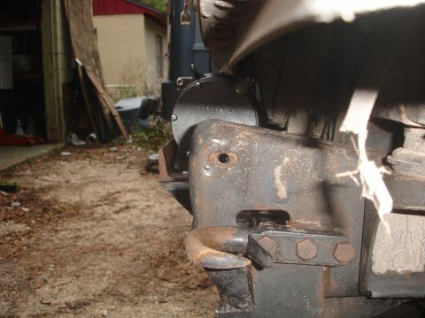 1989 Ford Bronco - Close-up view of a winch mount and tow hook assembly on a rusty metal frame.