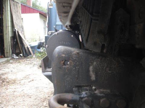 1989 Ford Bronco - Winch mount attached to the front bumper of a vehicle, with a house and garage visible behind.