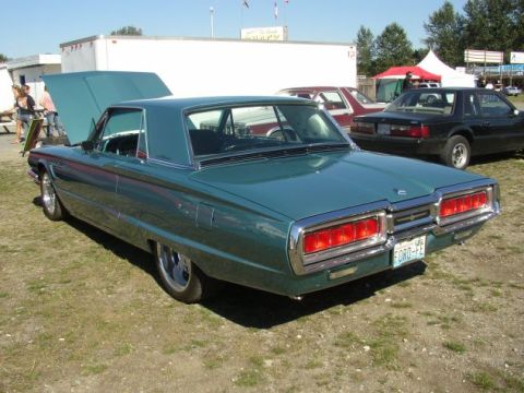 1969 Ford Fairlane - Teal 1967 Ford Thunderbird with hood open, parked outdoors with another vehicle behind it.
