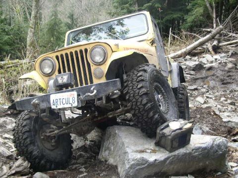 1979 Ford Bronco - This Jeep is navigating a rocky trail, with a jerry can secured on the rocks.